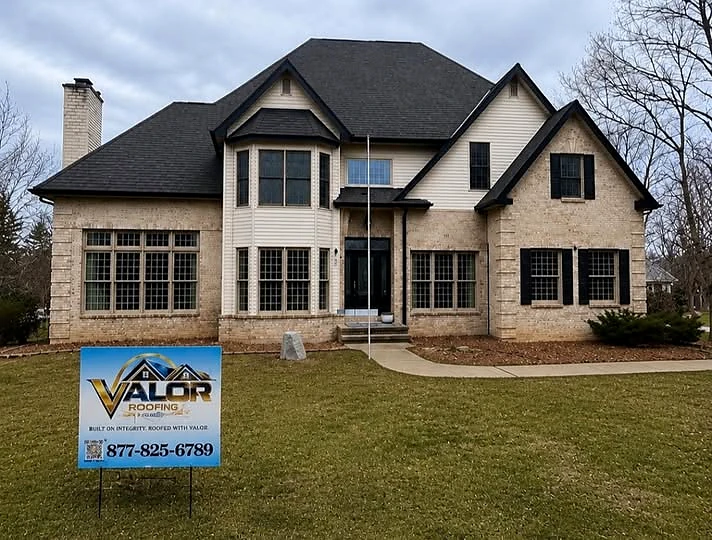 Completed residential roof replacement with Valor Roofing yard sign in Michigan